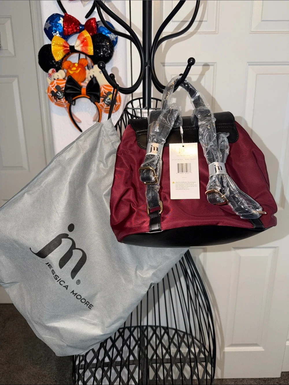 NWT Jessica Moore Burgundy Quilted Backpack with Black Flap Snap closures.
